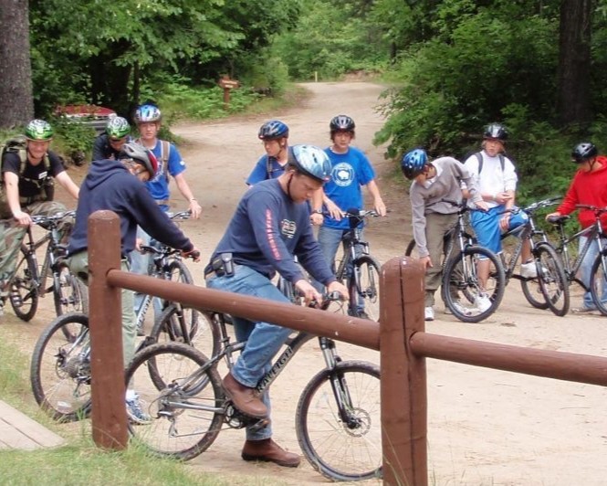 A group of Scouts are lined up on mountain bikes waiting to head out