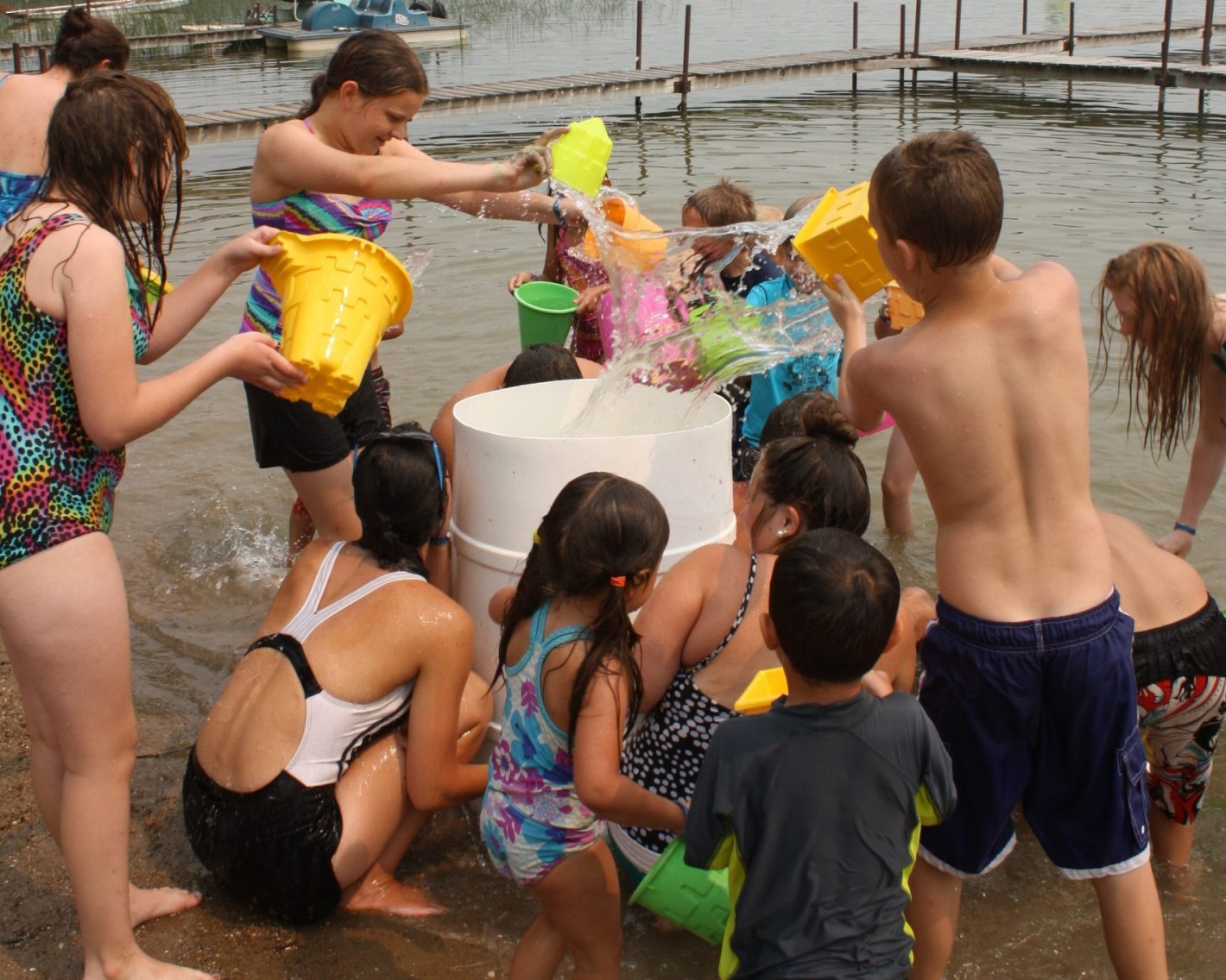 Picture of a group of people using buckets and throwing water around