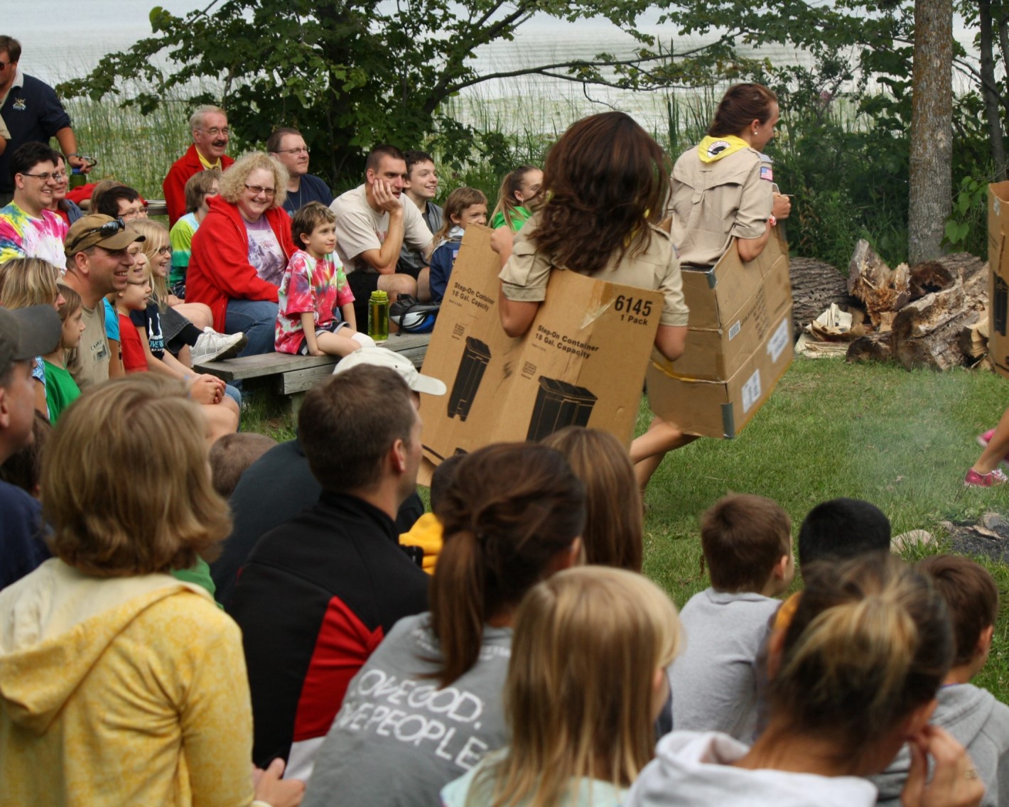 Picture of a group of participants smiling and laughing at a campfire skit