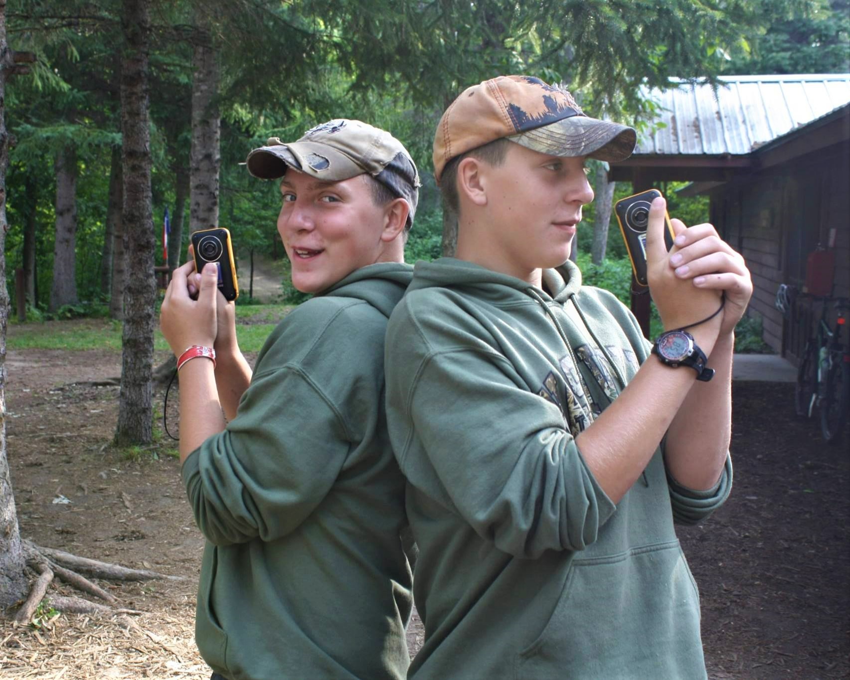 Two older Scouts are holding their cameras and striking a pose