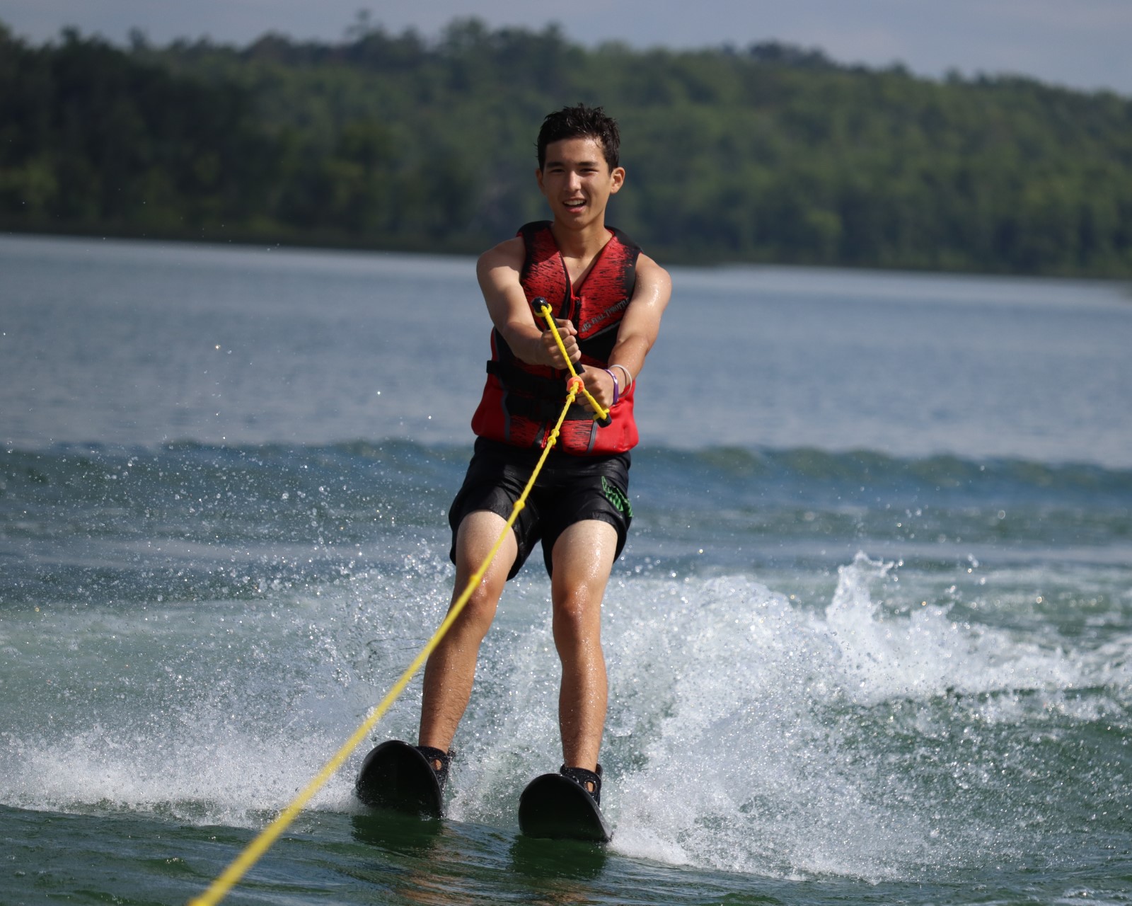 A Scout smiling while waterskiing